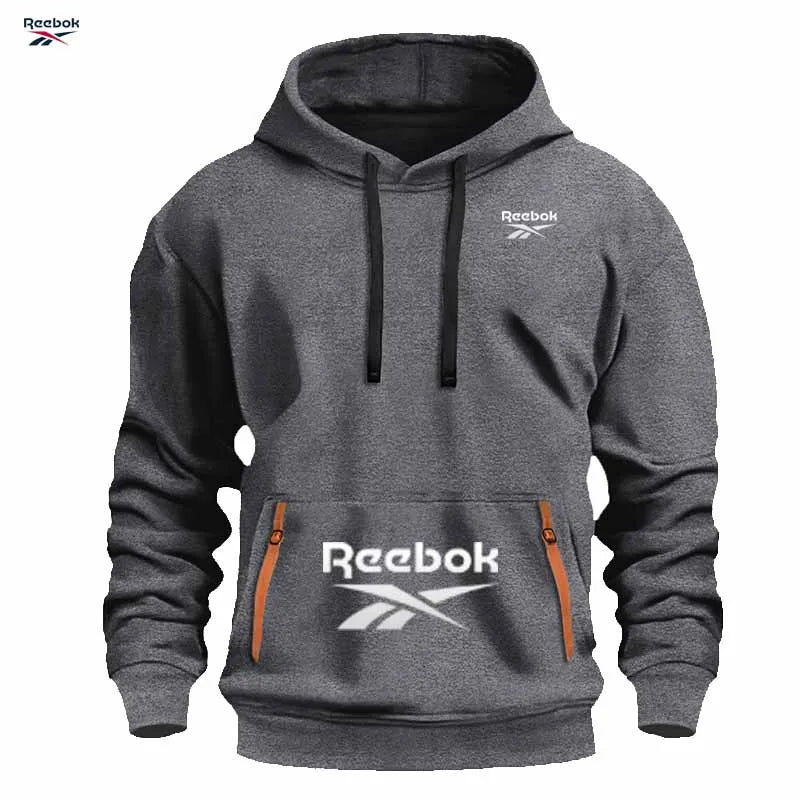 "Sudadera deportiva Reebok para hombre: sudadera con capucha tipo pullover, holgada y casual, de color liso con diseño de múltiples bolsillos, simple y limpia."