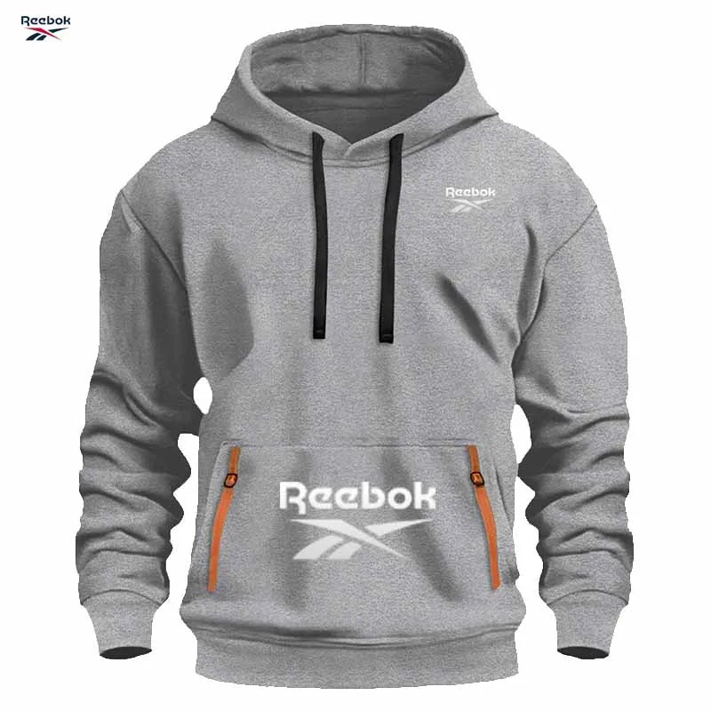 "Sudadera deportiva Reebok para hombre: sudadera con capucha tipo pullover, holgada y casual, de color liso con diseño de múltiples bolsillos, simple y limpia."