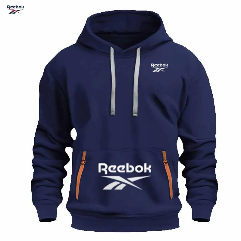 "Sudadera deportiva Reebok para hombre: sudadera con capucha tipo pullover, holgada y casual, de color liso con diseño de múltiples bolsillos, simple y limpia."