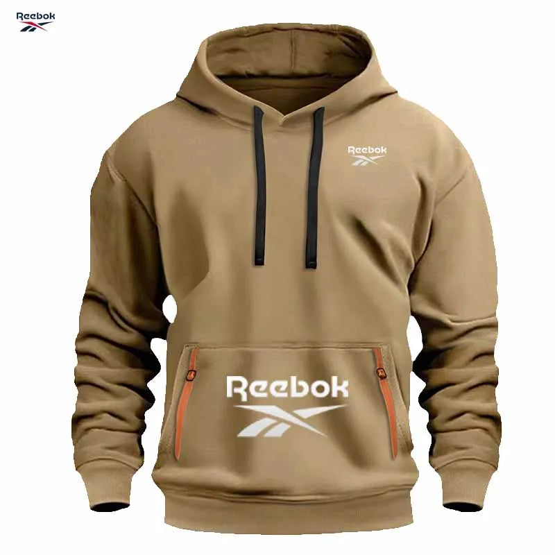 "Sudadera deportiva Reebok para hombre: sudadera con capucha tipo pullover, holgada y casual, de color liso con diseño de múltiples bolsillos, simple y limpia."